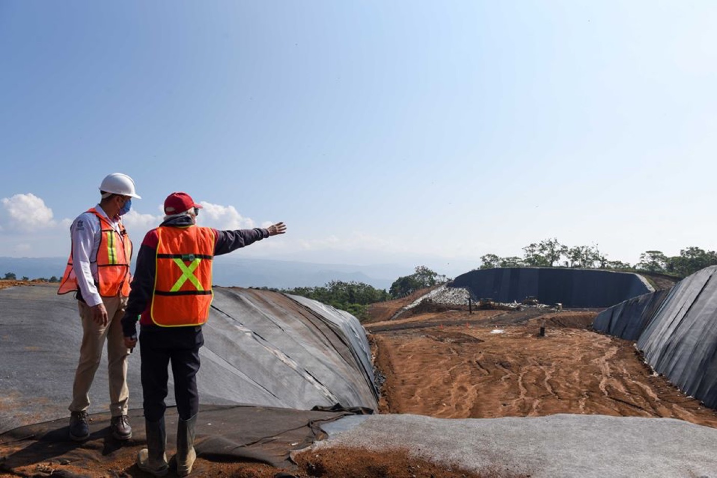 Cuadrilla instalando geomembrana en talud